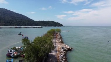 Georgetown, Penang, Malaysia - Dec 22 2021: Aerial view move over leisure asphalt road near fishing jetty