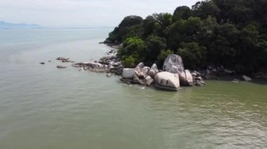 Aerial move forward to group of rock at sea coastal