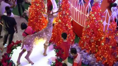 Bayan Lepas, Penang, Malaysia - Dec 26 2021: Select focus reindeer statue decoration in red Christmas tree ornament