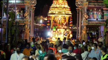 Georgetown, Penang, Malaysia - Jan 19 2022: Golden chariot leave the compound of Hindu temple in night celebrate Thaipusam