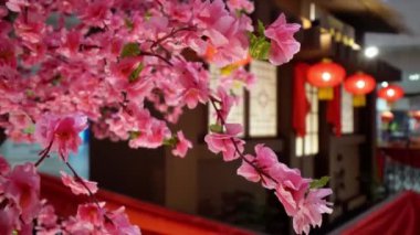 Select focus plum blossom flower with bokeh traditional Chinese house decoration at background