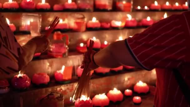 Close Hand Chinese Devotees Burn Incense Joss Stick Lotus Candle — Vídeo de Stock