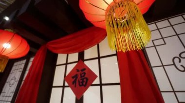Rotation and move away the red lantern in front of door decorated with Chinese character mean blessing good luck