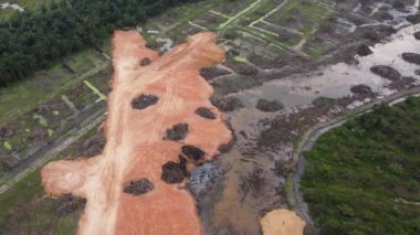 Aerial view red sand soil reclaim over oil palm estate for development