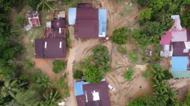 Aerial top down view tractor use to clear the mud after severe flood at village