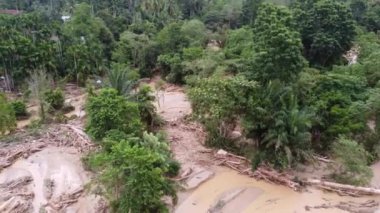 Serious flash flood with debris and mud destroy the rural area near the river