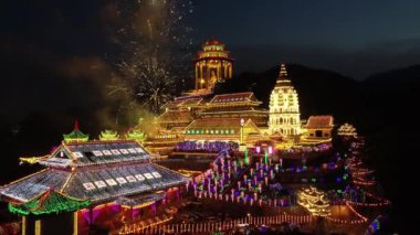 Ayer Itam, Penang, Malaysia - Jan 28 2022: Aerial view fireworks at Kek Lok Si temple in night led lighting