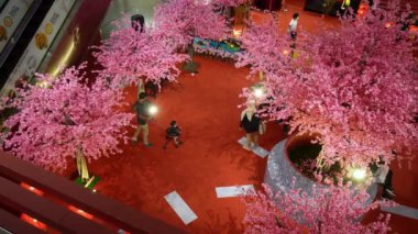 Georgetown, Penang, Malaysia - Feb 05 2022: Top down view people visit to decoration of plum blossom in mall during Chinese New Year