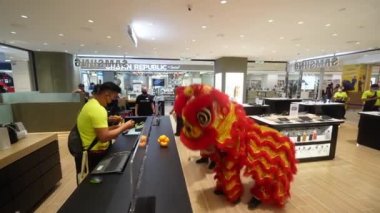 Gurney, Penang, Malaysia - Feb 08 2022: Lion dance throw the vegetable at Samsung shop blessing during Chinese New Year