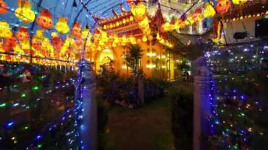 Ayer Itam, Penang, Malaysia - Feb 25 2022: Slow move and tilt up view the Kek Lok Si Temple with led illuminated lantern during blue hour