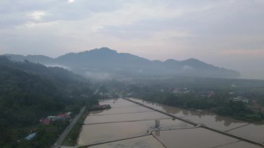 Balik Pulau, Penang, Malaysia - Mar 13 2022: Aerial view water season at paddy field with mural in the field