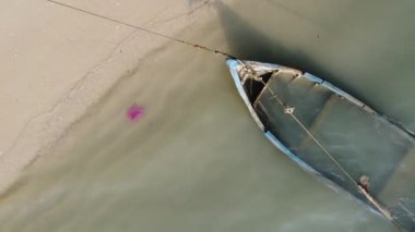 Aerial top down view red plastic near the sinking boat at sea coastal