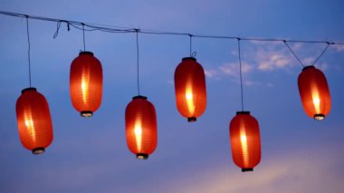 Close up Japan lantern ornament hanging during blue hour during Bon Odori