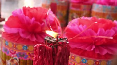 Large candle burn with background of joss paper offering for hungry ghost king