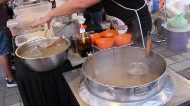 Select focus preparation of wantan mee at food festival. Delicious Malaysia street food