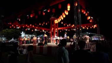 Georgetown, Penang, Malaysia - Jul 30 2022: People on stage and below stage dance during Bon Odori