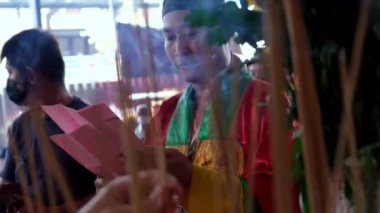 Bukit Mertajam, Penang, Malaysia - Jul 31 2022: Chinese taoist priest chanting in front of joss stick