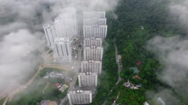 Aerial look down low cloud of car move at Jalan Paya Terubong near flat and forest