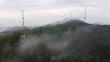 Aerial view morning mist cloud at three telecommunication tower