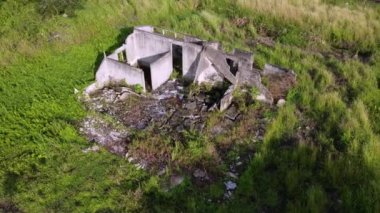 Aerial rotation abandoned concrete building in evening sun light