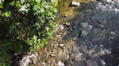 Bird eye view water flow over rock in sun light