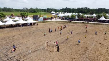 Kampung Terus, Penang, Malezya - 23 Haziran 2022: Sıcak güneşli bir günde Bendang çeltik sahasında insanlar futbol oynuyor