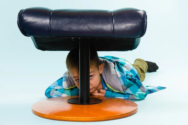 Kleine jongen en voetenbankje — Stockfoto