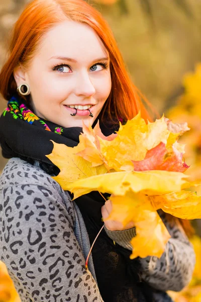 Red-haired girl and maple leaf — Stock Photo, Image