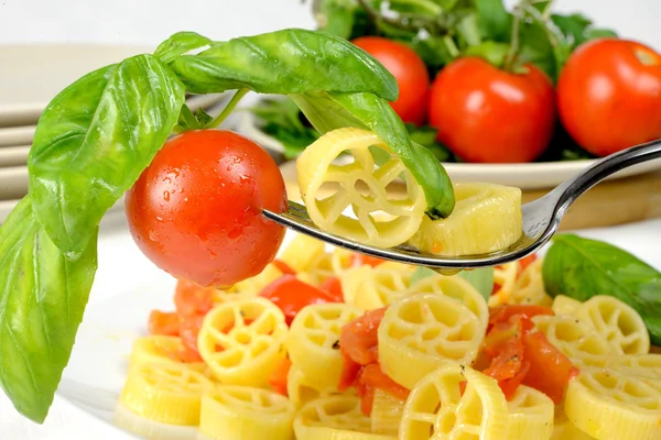 Rodas de macarrão com tomates frescos — Fotografia de Stock