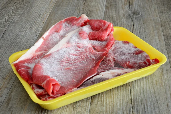 Frozen steaks of meat — Stock Photo, Image