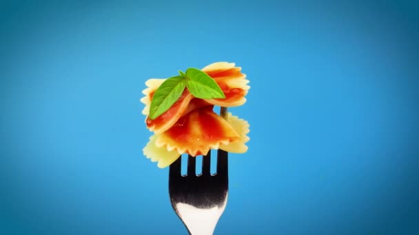 Pasta Farfalle Con Salsa Tomate Girando Sobre Fondo Azul — Vídeos de Stock