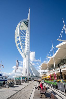 29 Eylül 2021 'de İngiltere' nin Portsmouth, Hampshire kentindeki Gunwharf Quay outlet alışveriş merkezinin önündeki limanda bulunan Spinnaker Kulesi ve lokantalar