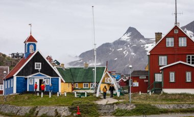 Old red and blue wooden Bethel church with whale bone arch  in Sisimiut, Greenland on 16 July 2022