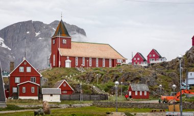 New church and clock tower on rocky outcrop in Sisimuit, Greenland on 16 July 2022