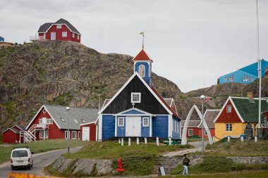 Old red and blue wooden Bethel church with whale bone arch  in Sisimiut, Greenland on 16 July 2022