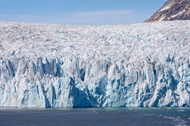 Close up of the huge face of a craggy glacier in Prince Christian Sound, South Greenland
