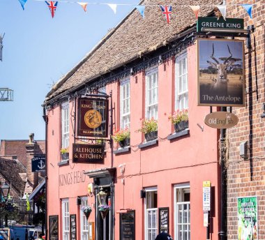 Three different pub signs in a row, for three different breweries, in Poole, Dorset, UK on 11 August 2022