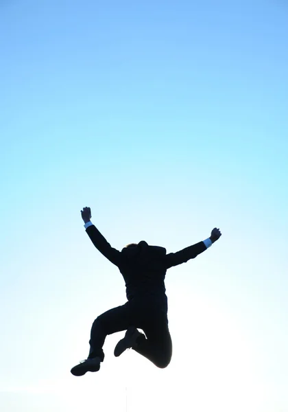 Jumping businessman and blue sky Royalty Free Stock Images