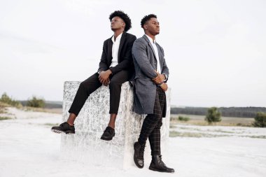 İki modaya uygun Afrikalı siyah erkek, açık havada, şık klasik kıyafetler içinde, şık saç stili, yakışıklı erkekler, manken portresi, moda konsepti, erkek giyimi