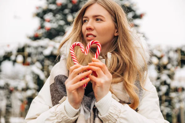 Happy Woman Warm Clothes Christmas Candies Her Hands Stands Decorated — Fotografia de Stock