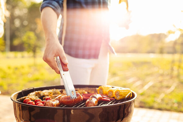 Man Prepares Barbecue Friends Happy Young Friends Make Barbecue Outdoors Stock Image