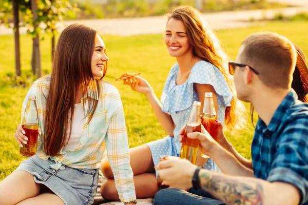 Grupa Przyjaciół Smakuje Pizzą Parku Mężczyźni Kobiety Siedzą Trawie Wokół — Zdjęcie stockowe