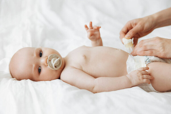 Side View Portrait Happy Mother Changing Her Baby Diaper Bed Stock Image