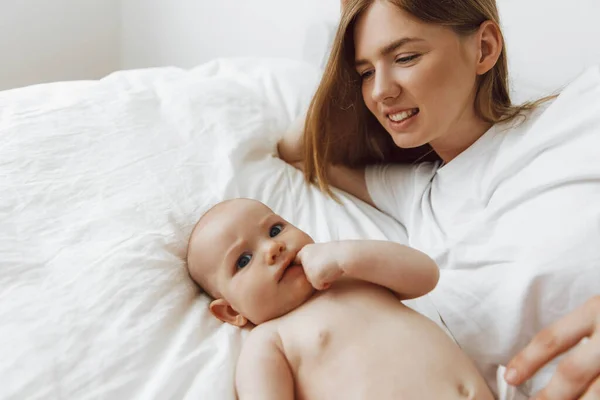 Portrait Caring Loving Mother Kissing Her Little Newborn Daughter Bed — Stok Foto