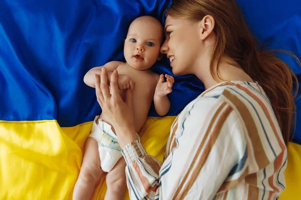 Loving Caring Mother Her Newborn Baby Lies Background Ukrainian Blue — Stok Foto