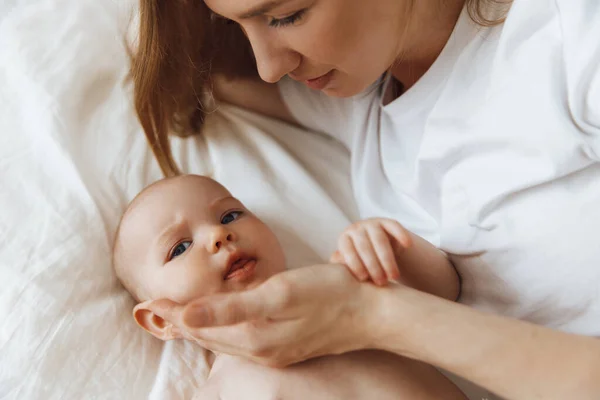 Portrait Caring Loving Mother Kissing Her Little Newborn Daughter Bed — Stockfoto