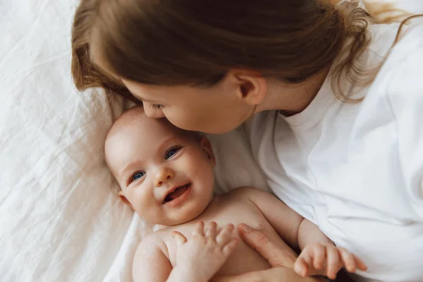 Portrait Caring Loving Mother Kissing Her Little Newborn Daughter Bed — Stockfoto