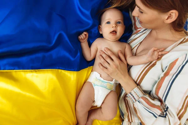 Loving Caring Mother Her Newborn Baby Lies Background Ukrainian Blue — Stok Foto