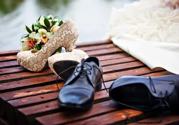 Wedding shoes on the bridge near the water — Stock Photo, Image