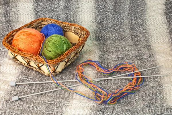 Heart of yarn of different colors with knitting needles — Stock Photo, Image